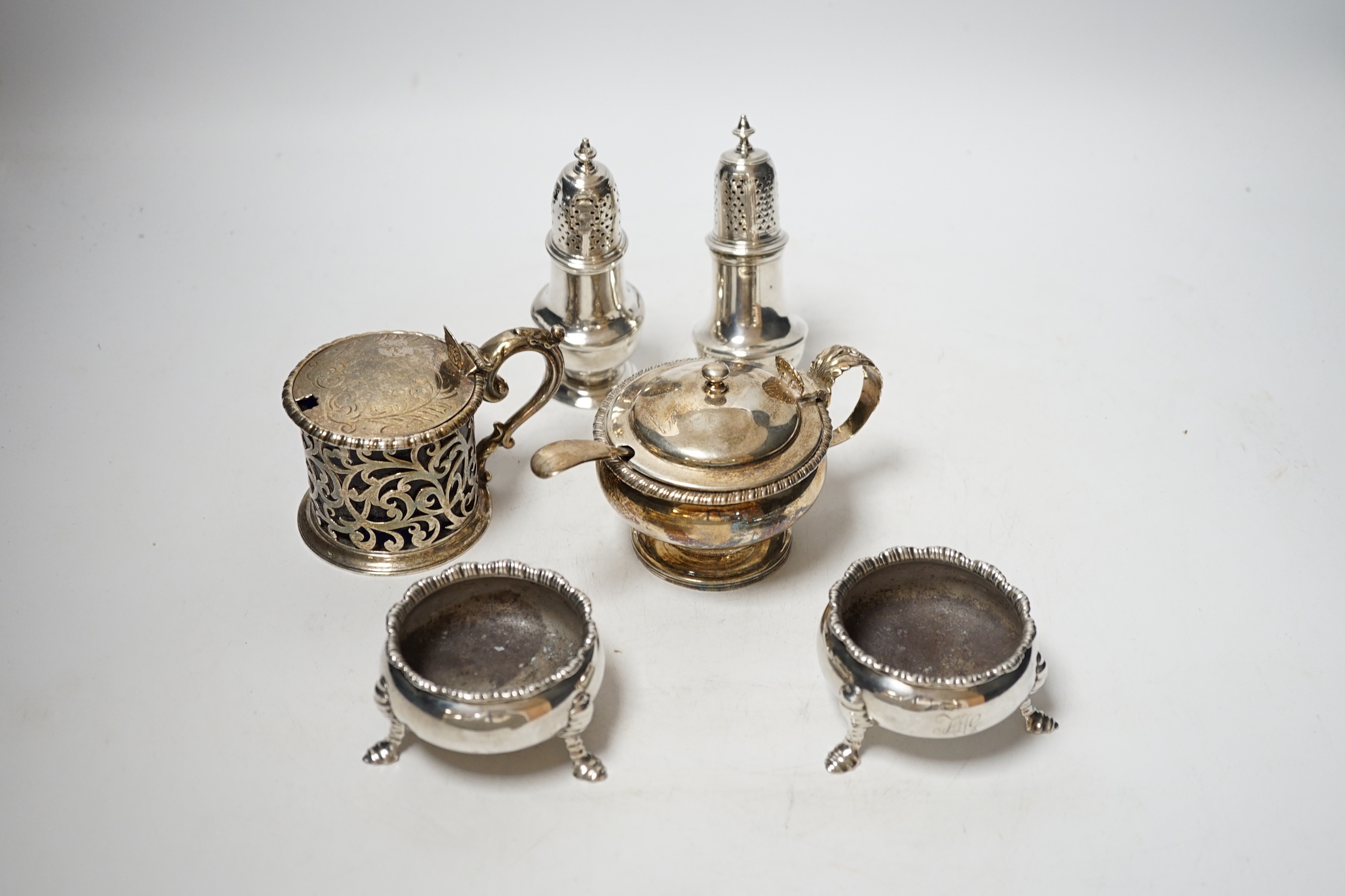 A collection of small silver items to include a pair of Georgian cauldron salts, two mustard pots including London, 1828 and London, 1850 and two George II pepperettes, London, 1749 and 1749, one a.f.